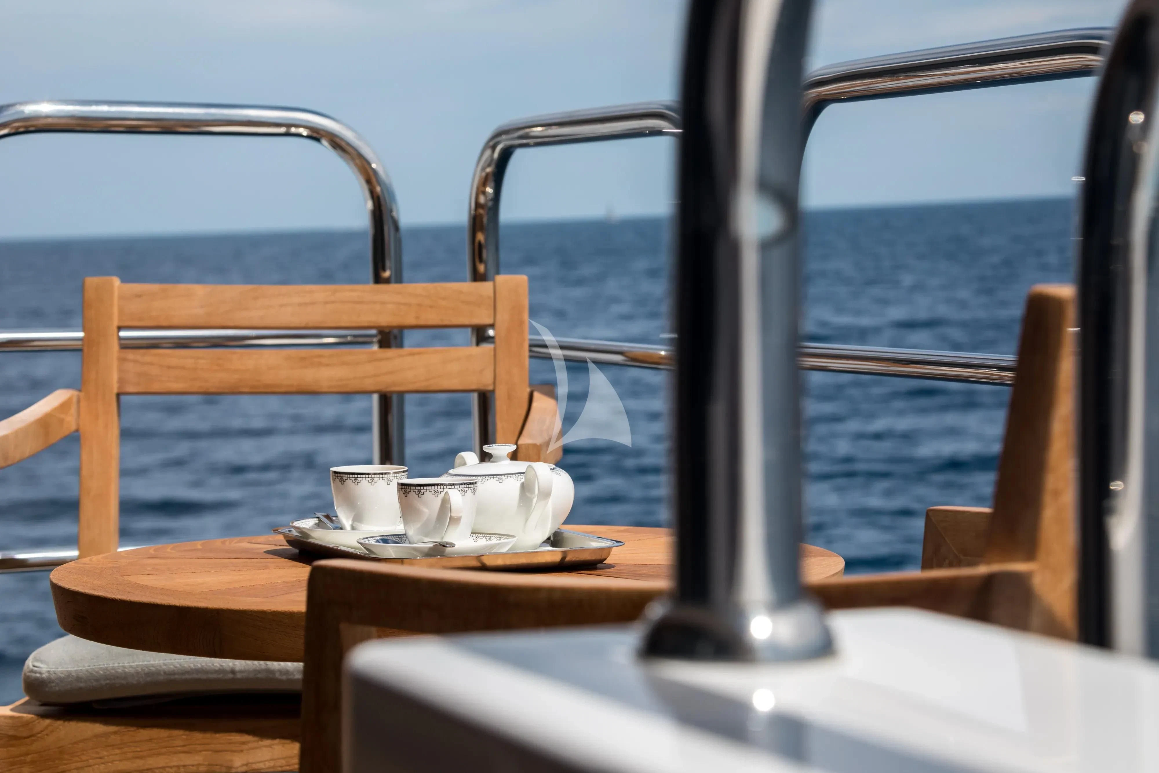 a table with a cup and a plate on it aboard ARADOS Yacht for Charter