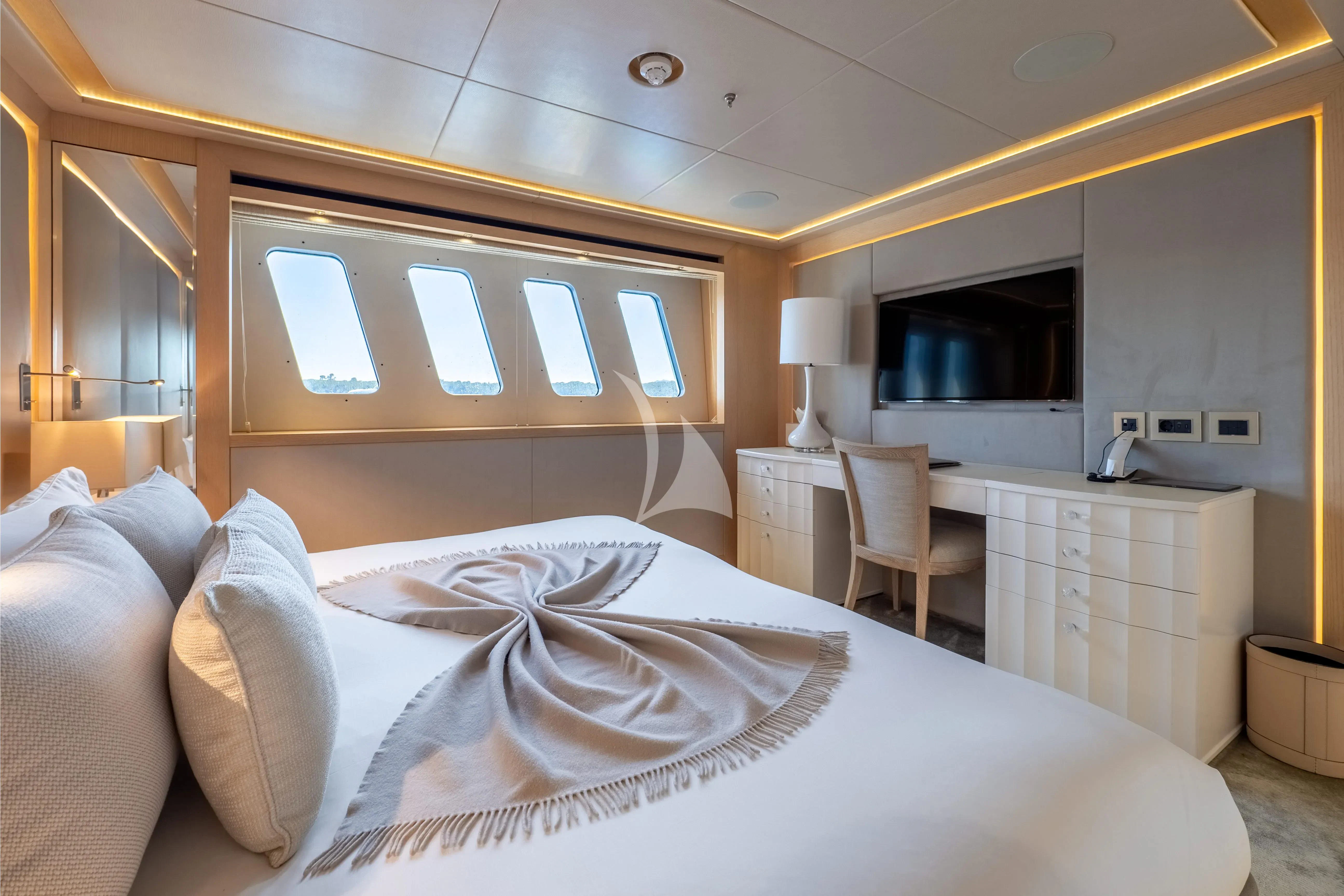 a bed with a white bed spread aboard ARADOS Yacht for Charter