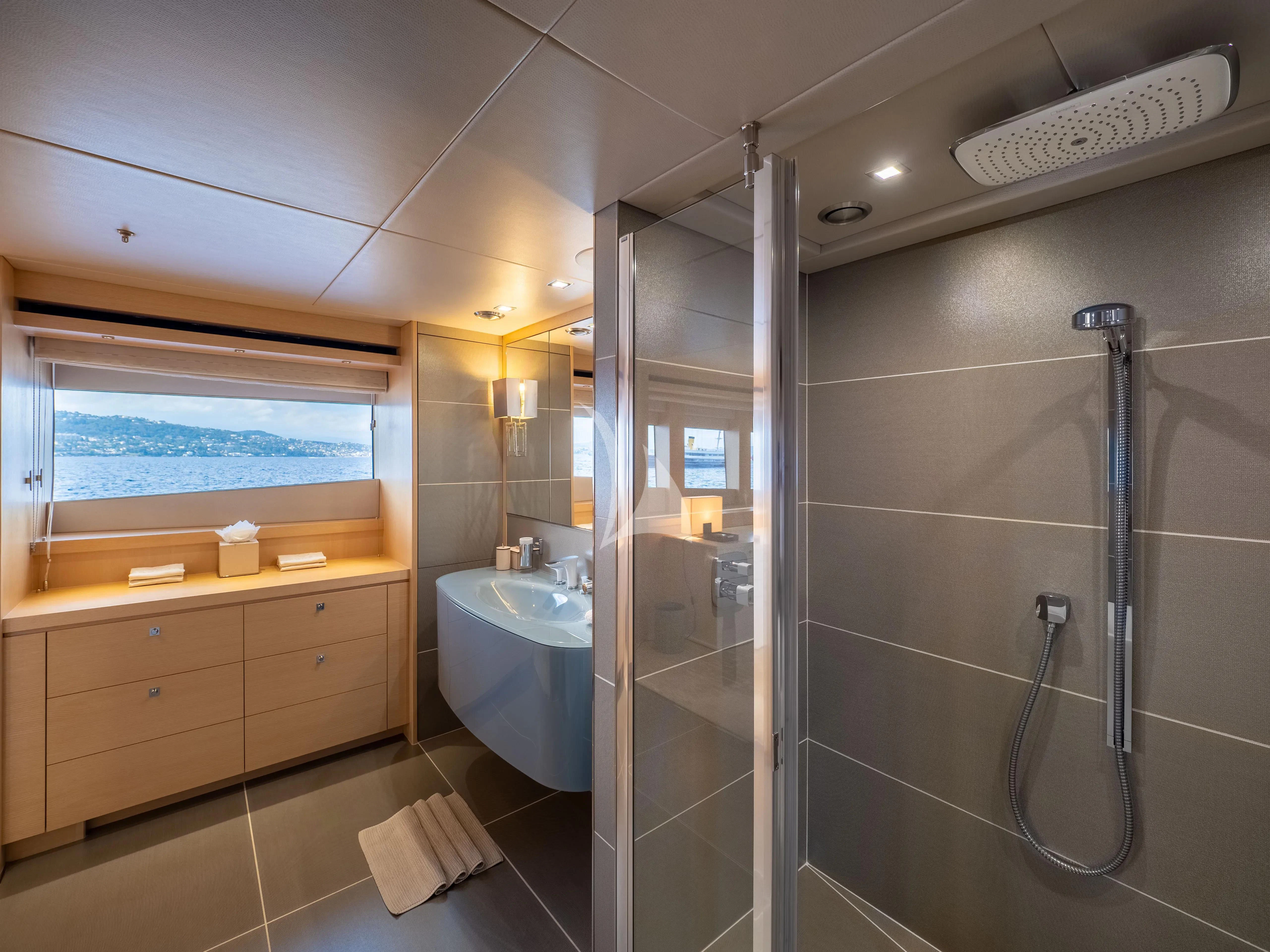 a bathroom with a shower unit and sink aboard ARADOS Yacht for Charter