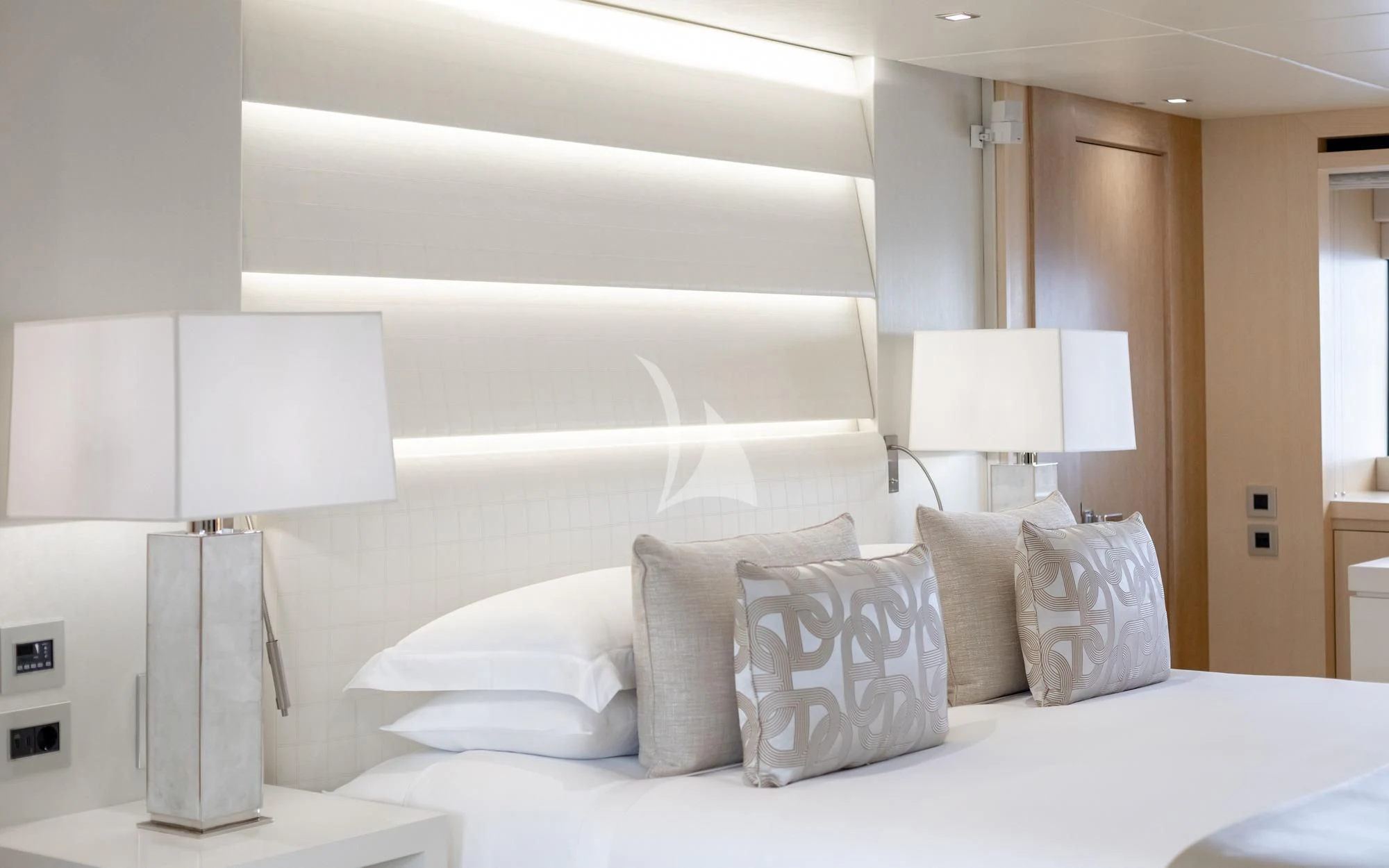 a bed with pillows aboard ARADOS Yacht for Charter