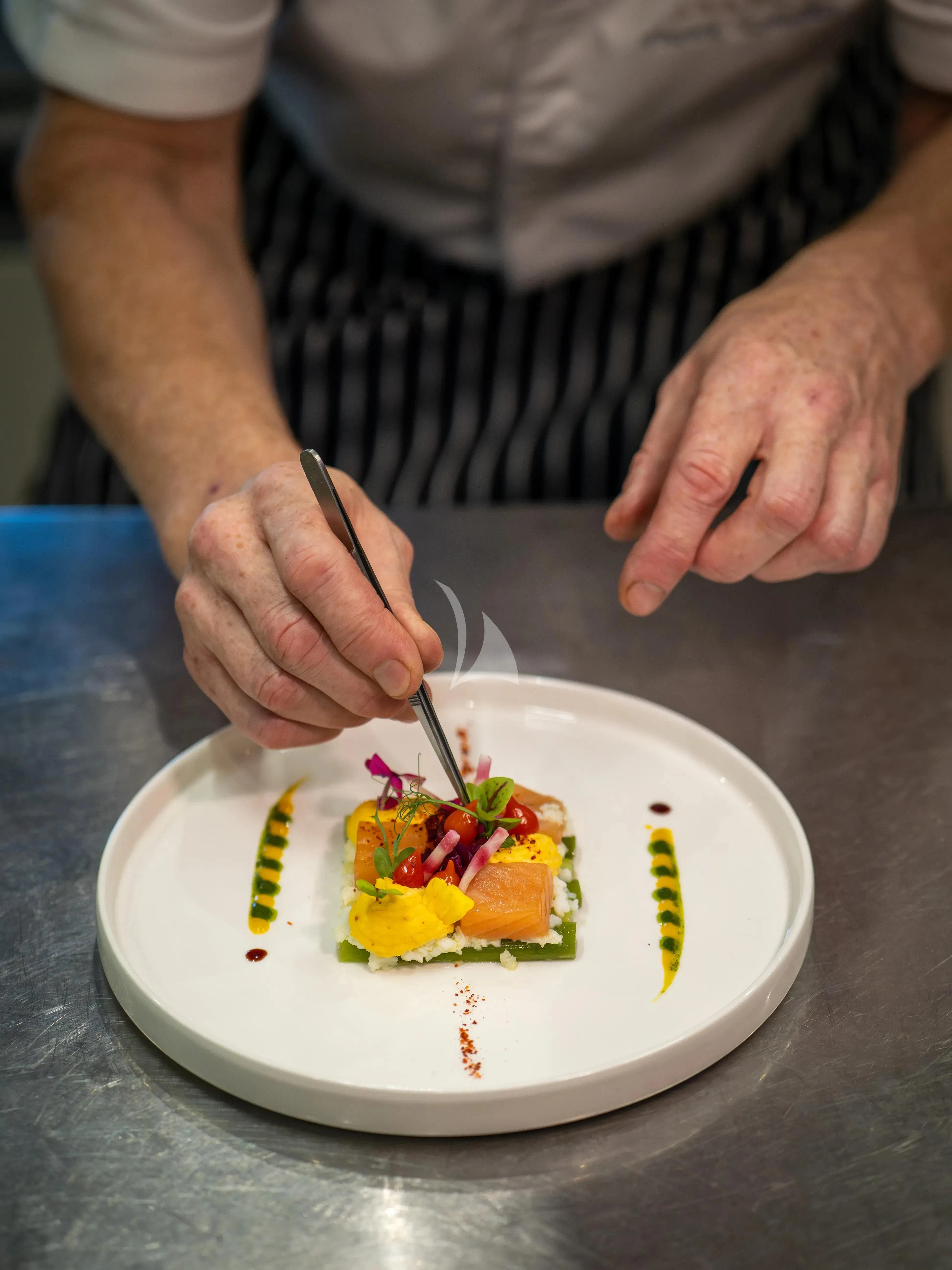 a person cutting a cake aboard ARADOS Yacht for Charter