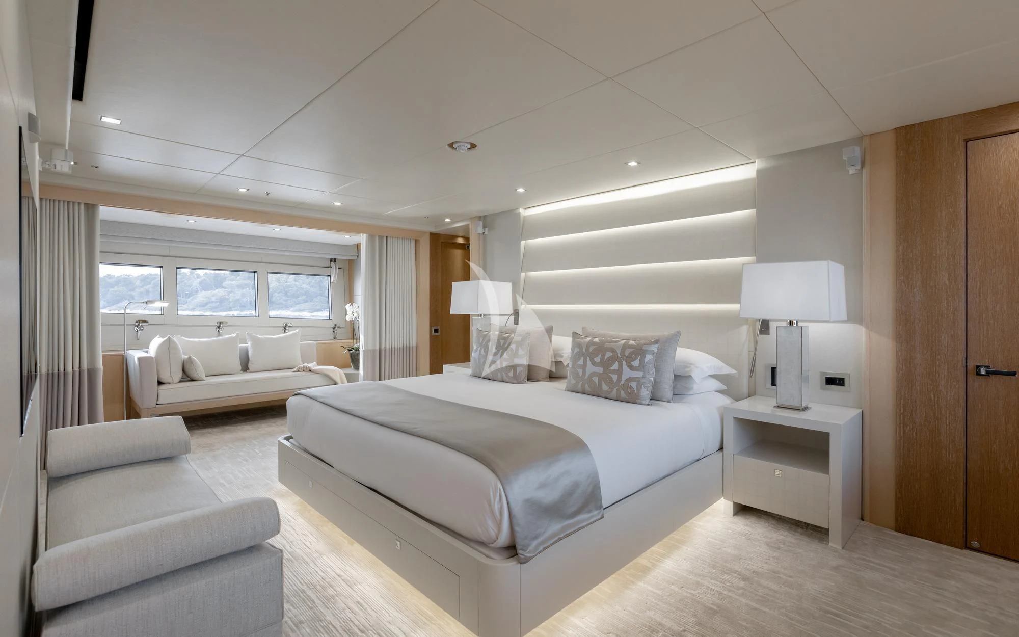 a bedroom with a bed and a desk aboard ARADOS Yacht for Charter