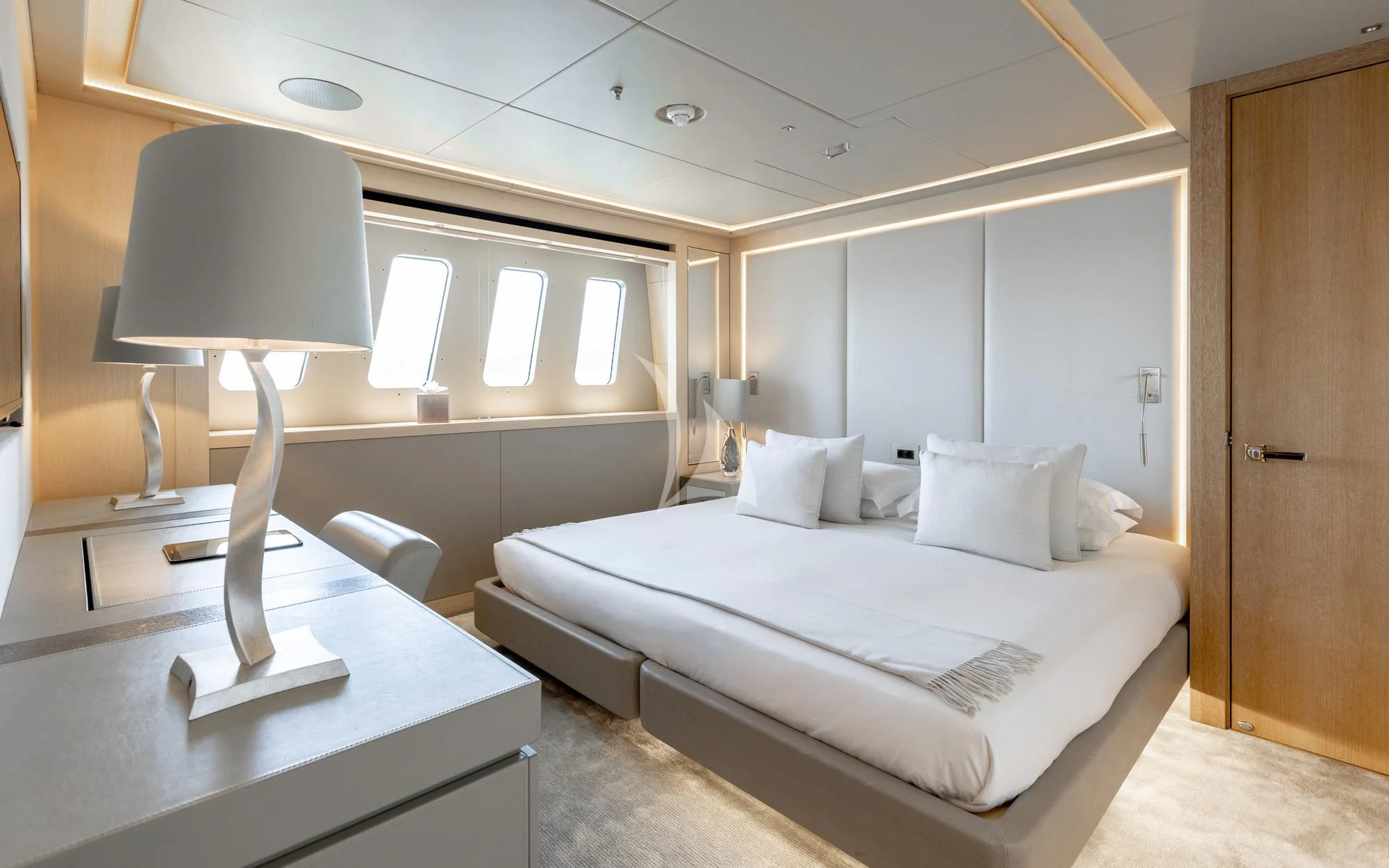 a bed with a lamp on it aboard ARADOS Yacht for Charter