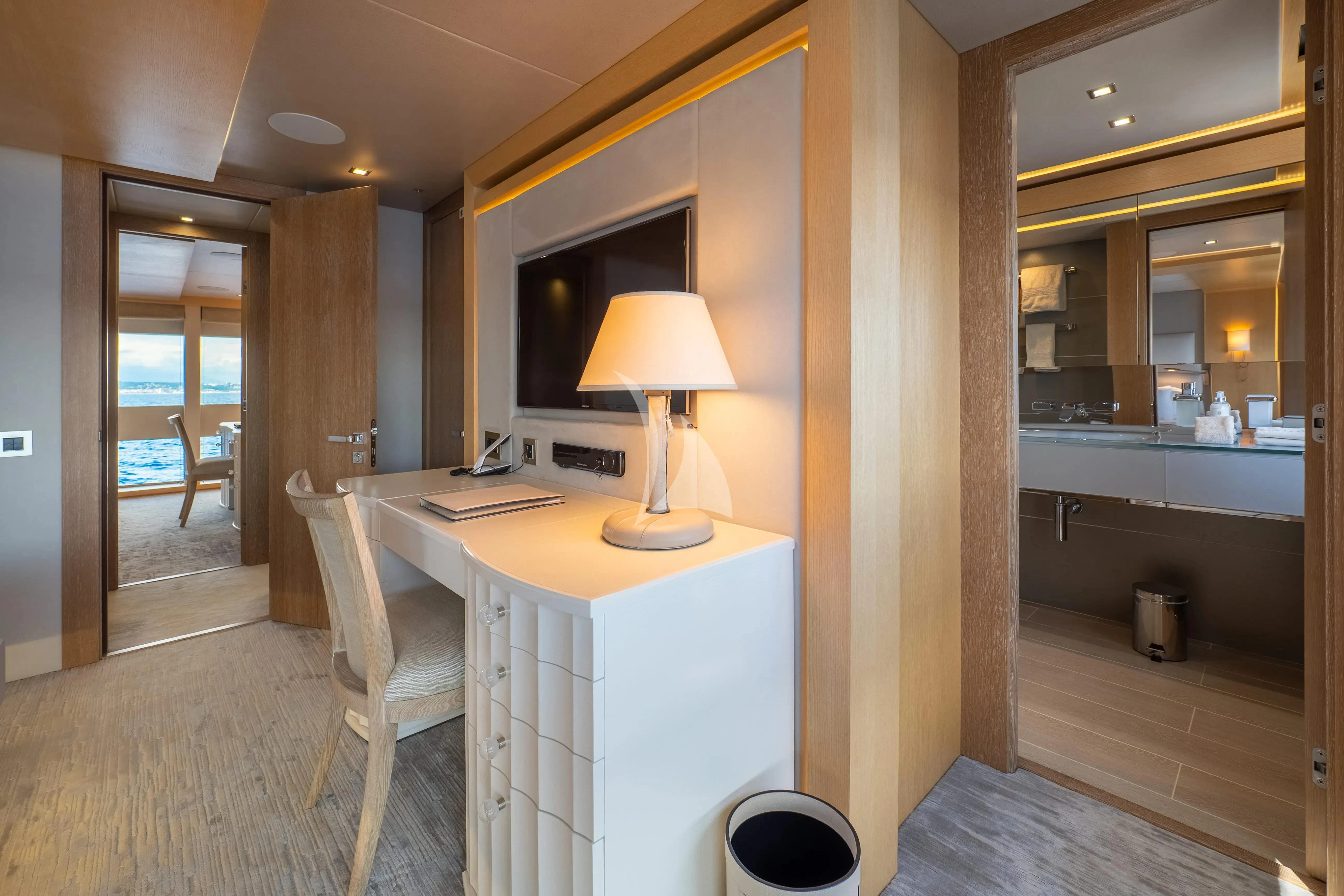 a room with a desk and a lamp aboard ARADOS Yacht for Charter