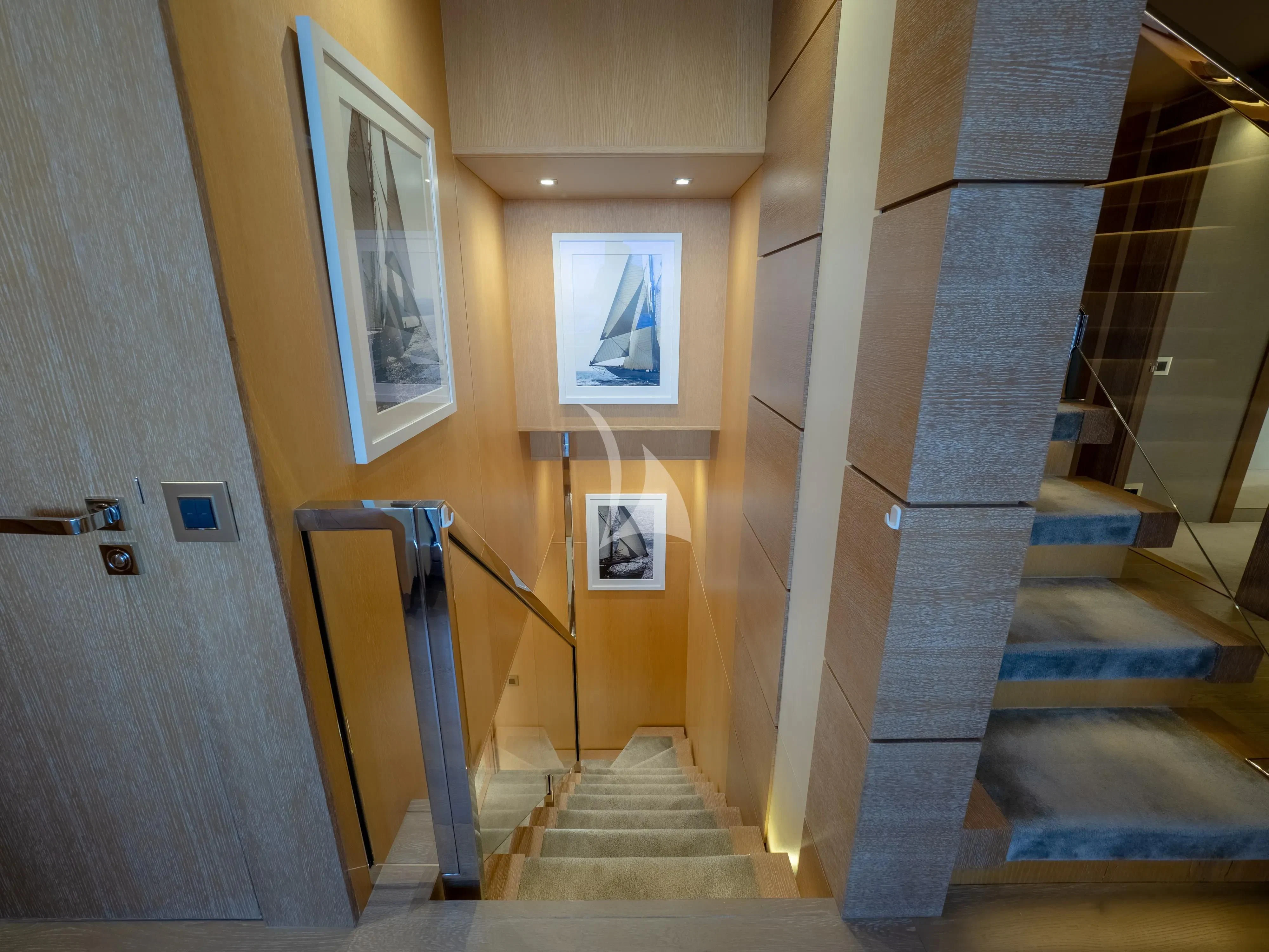 a staircase with a painting on the wall aboard ARADOS Yacht for Charter