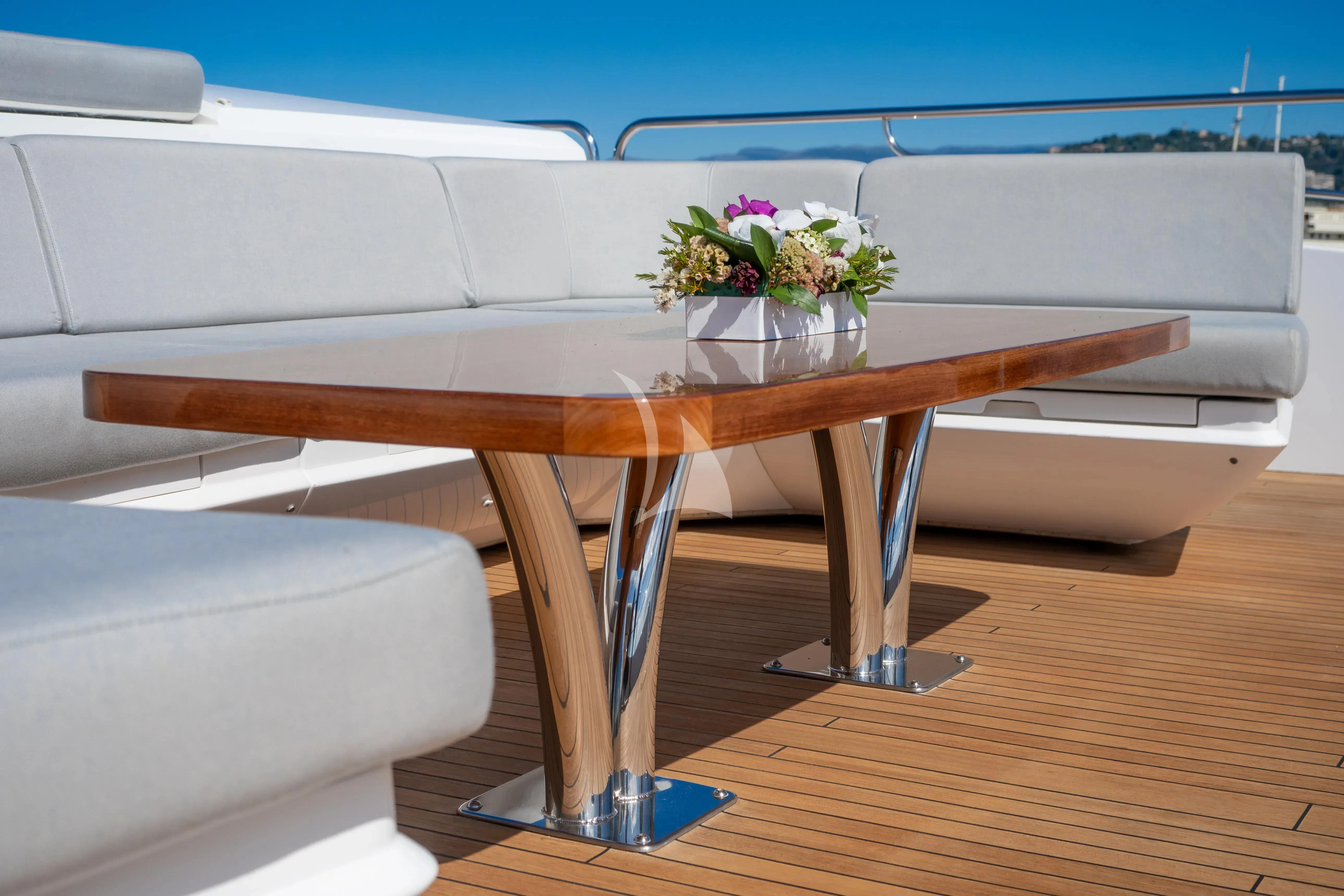 a table with flowers on it aboard ARADOS Yacht for Charter