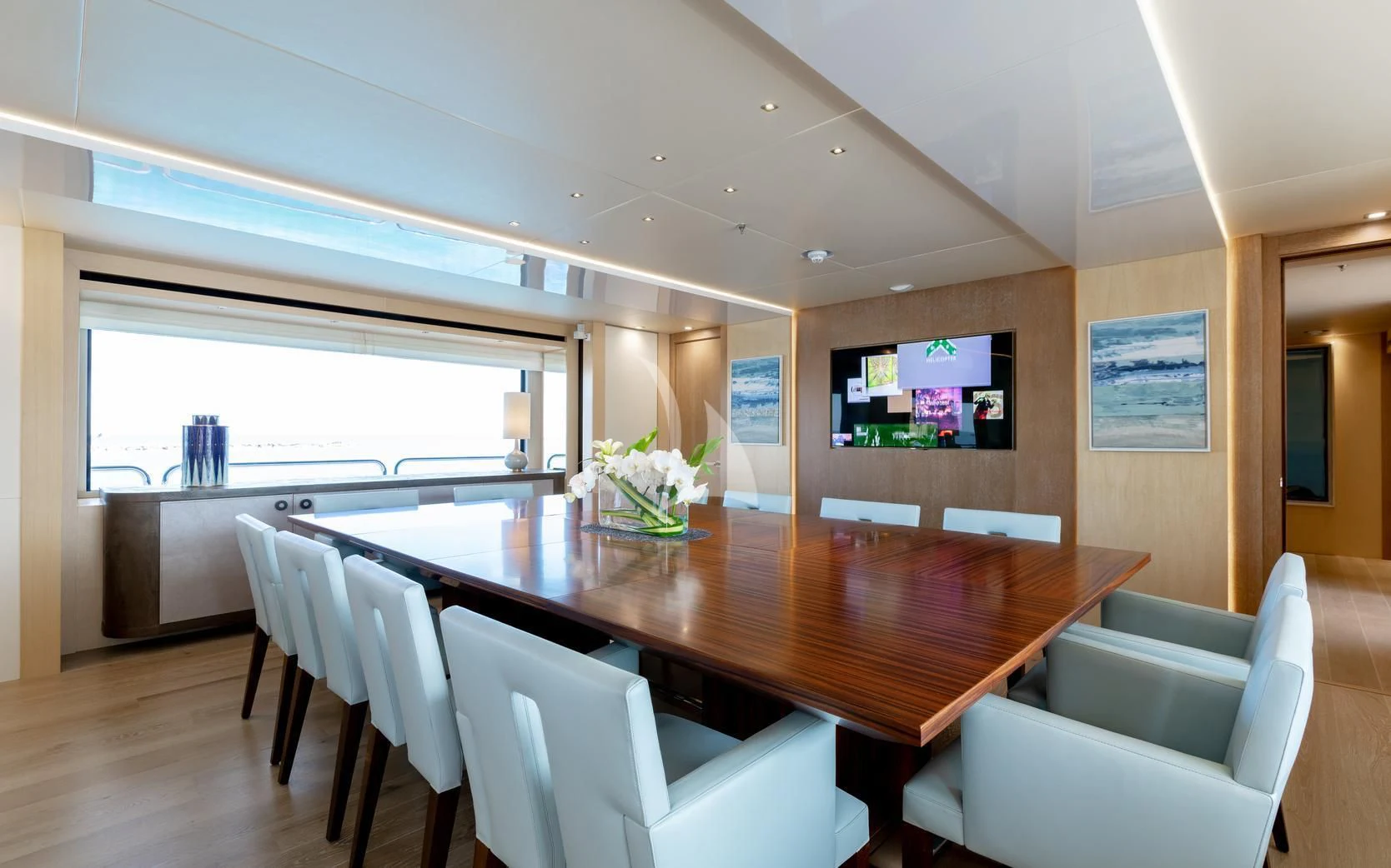 a large dining table in a room aboard ARADOS Yacht for Charter