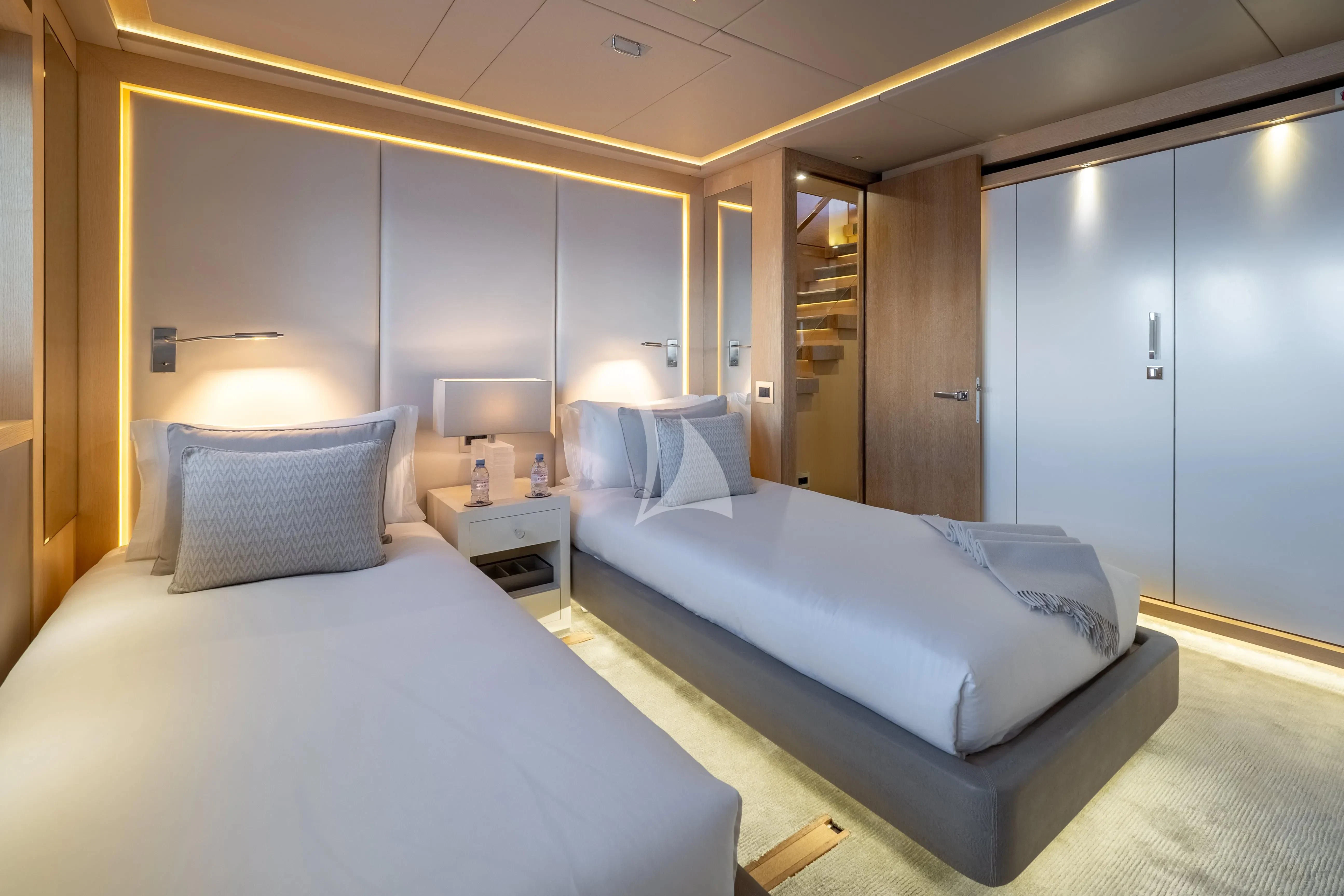 a hotel room with two beds aboard ARADOS Yacht for Charter