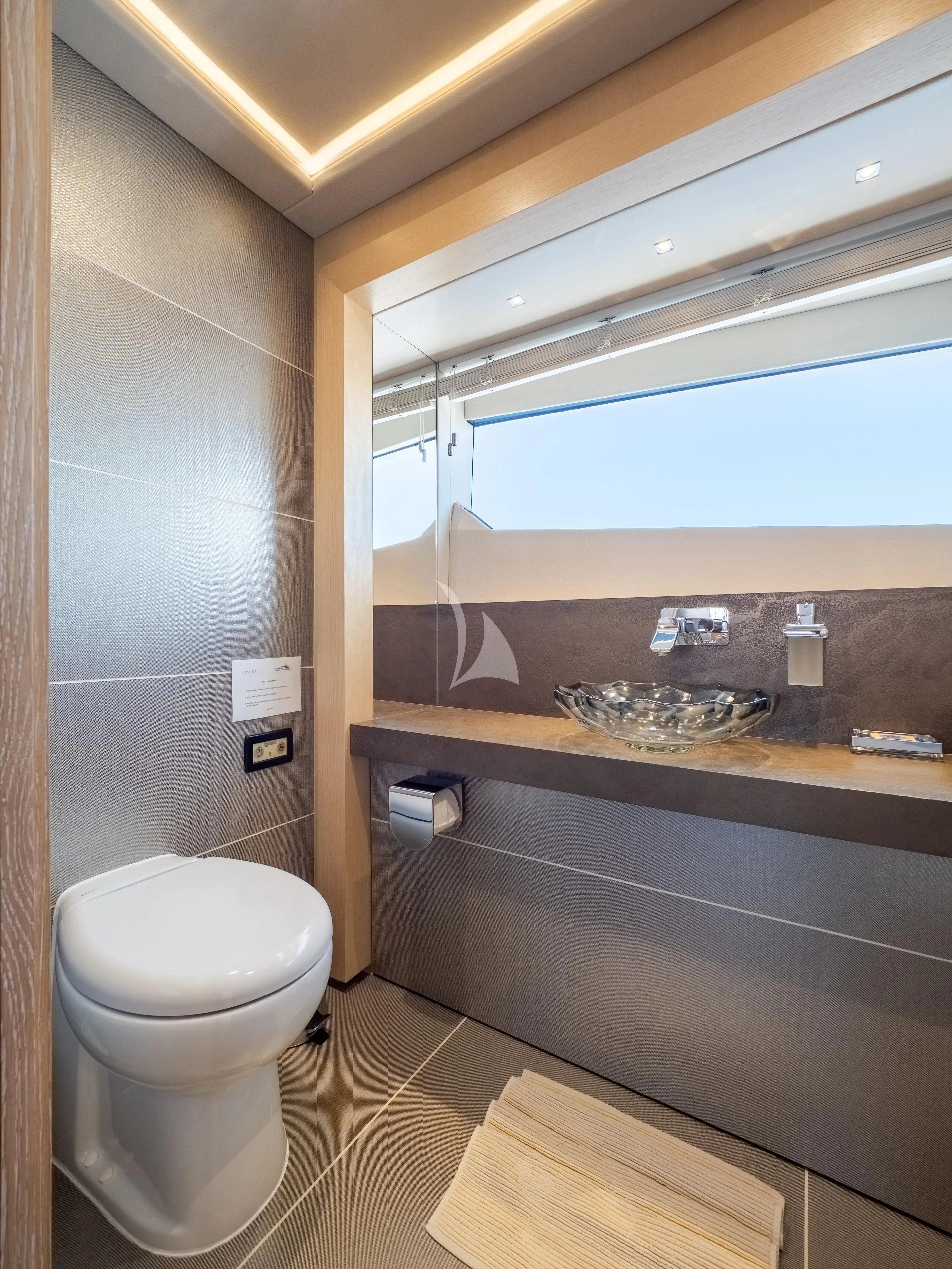 a bathroom with a sink and toilet aboard ARADOS Yacht for Charter