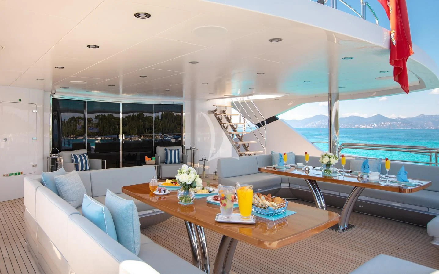 a living room with a large table and chairs aboard ARADOS Yacht for Charter