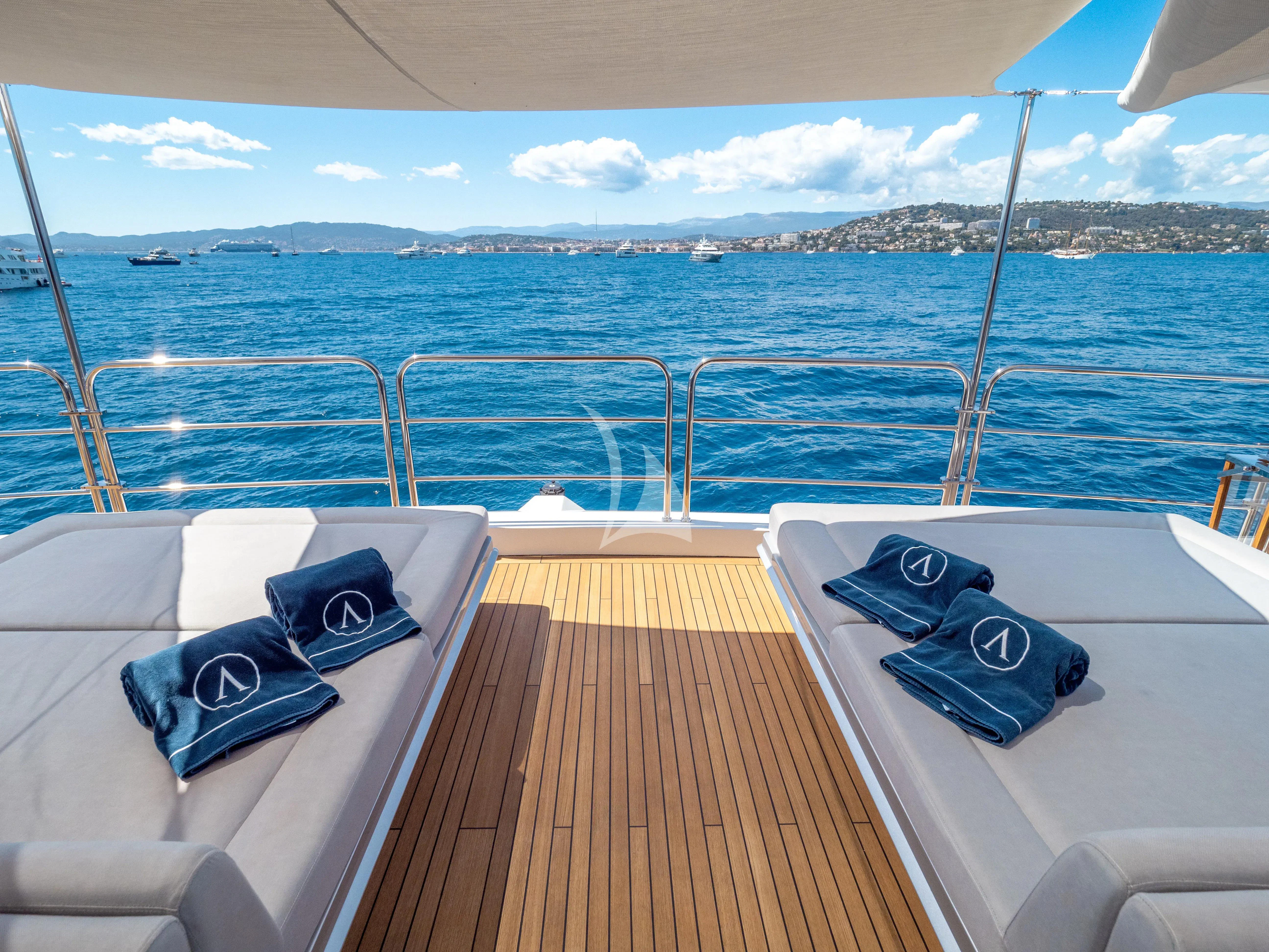 a deck with chairs and a table on it aboard ARADOS Yacht for Charter