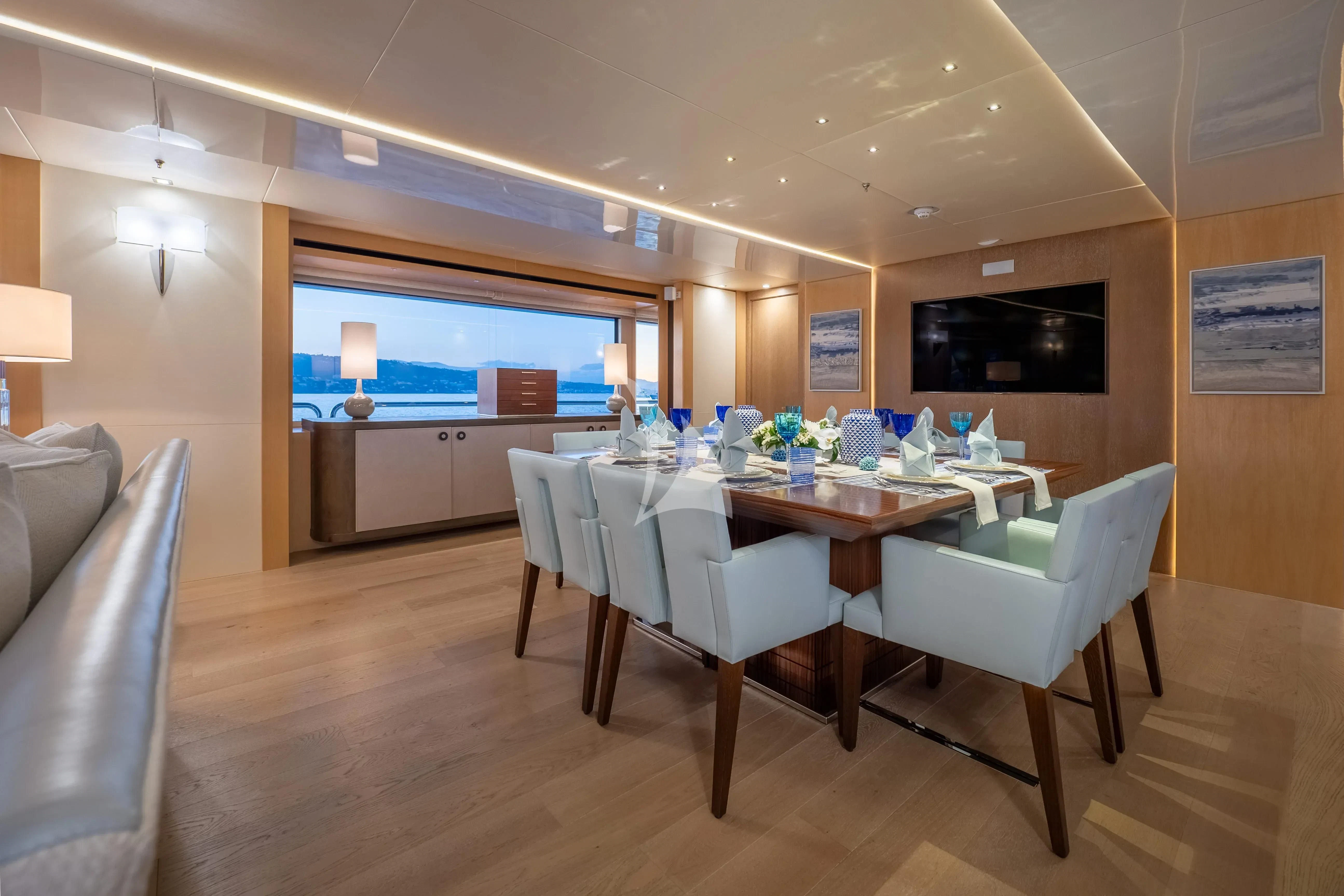 a large room with a table and chairs aboard ARADOS Yacht for Charter