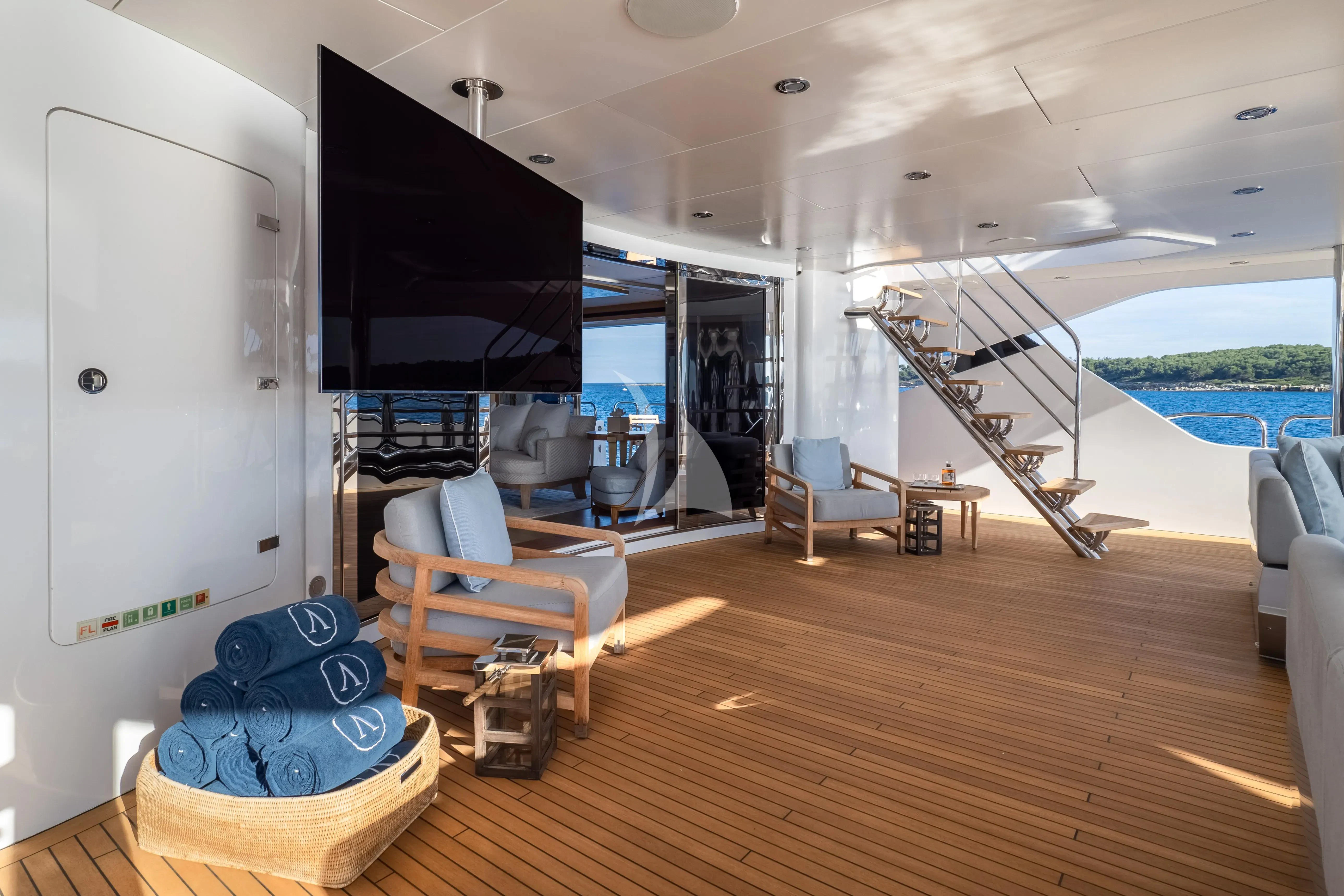 a room with a tv and furniture aboard ARADOS Yacht for Charter