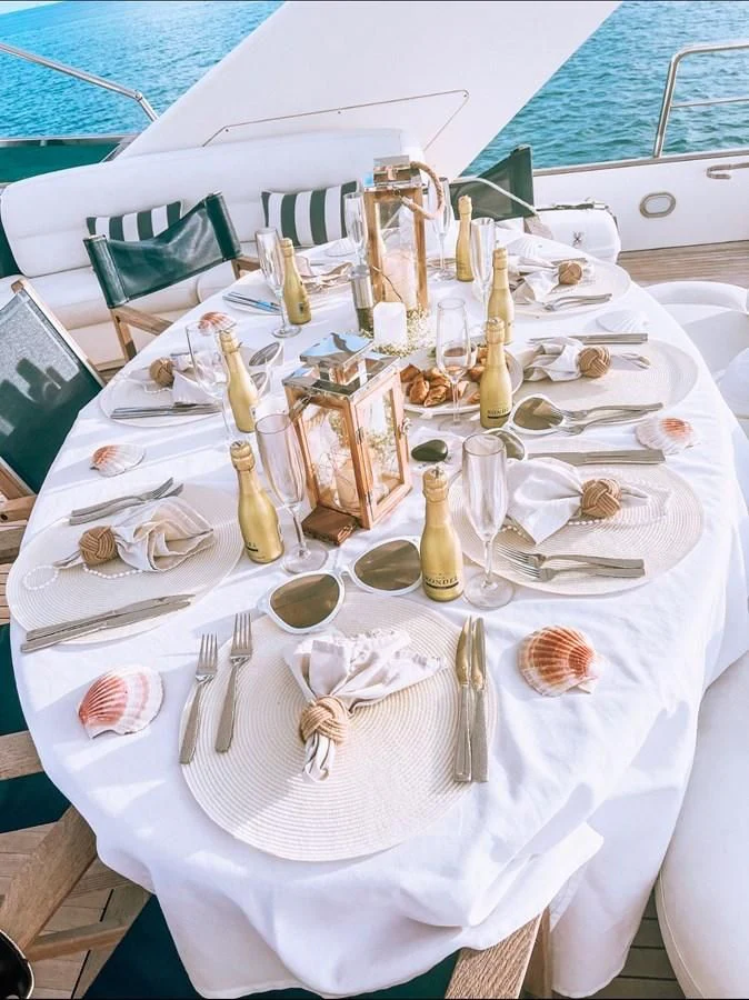 a table with plates and silverware aboard REFLECTION Yacht for Sale