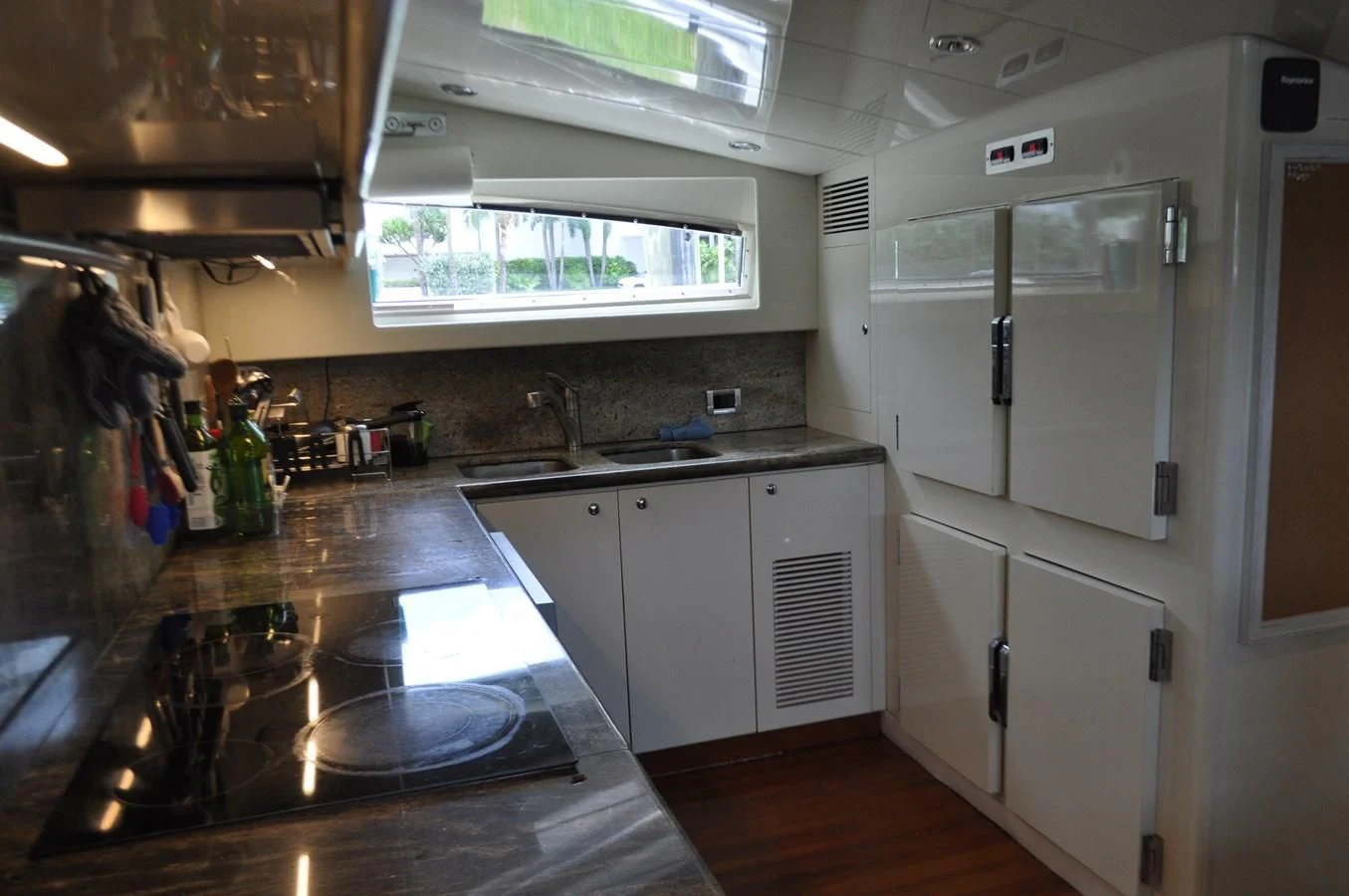 a kitchen with white cabinets aboard REFLECTION Yacht for Sale