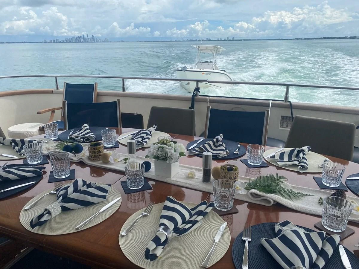 a table with plates and glasses on it aboard REFLECTION Yacht for Sale