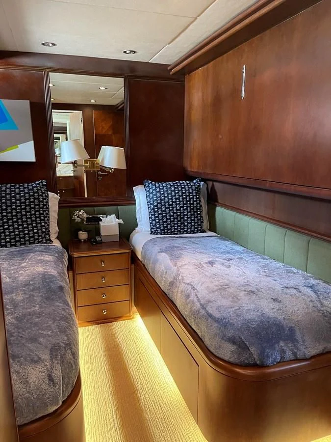 a bedroom with a bed and a mirror aboard REFLECTION Yacht for Sale