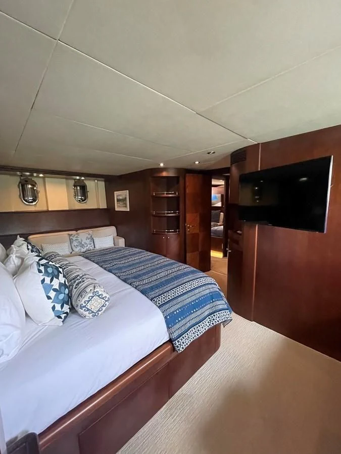 a room with a bed and a television aboard REFLECTION Yacht for Sale