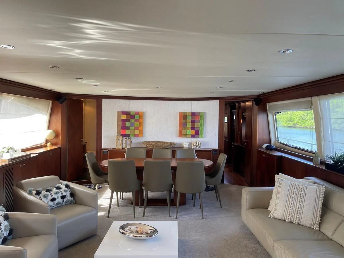 a living room with a table and chairs aboard REFLECTION Yacht for Sale