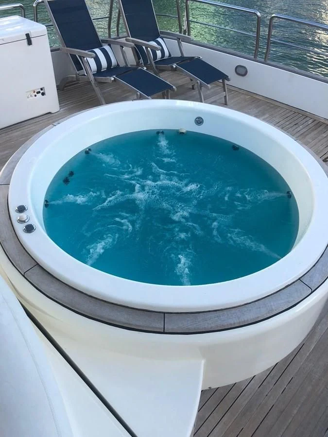 a pool with a table and chairs aboard REFLECTION Yacht for Sale