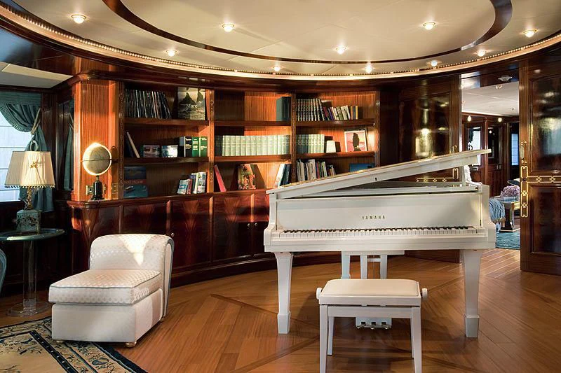 a piano in a library aboard BEOL Yacht for Sale