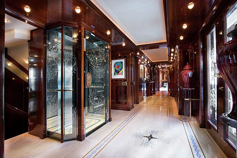 a long hallway with glass doors aboard BEOL Yacht for Sale