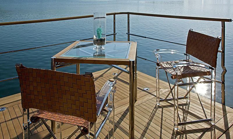 a table and chairs on a deck aboard BEOL Yacht for Sale