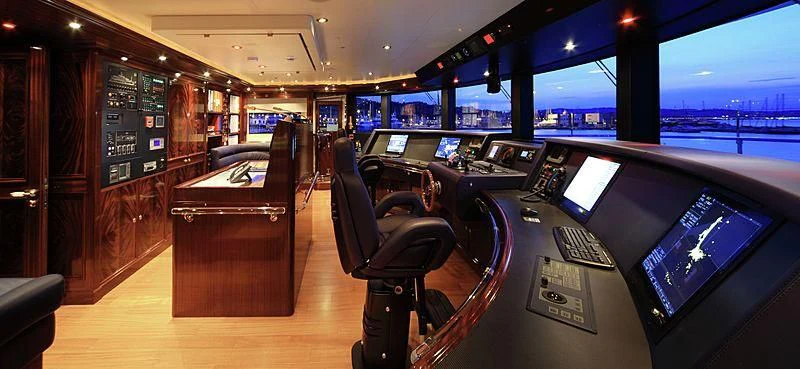 a room with a row of computer screens and a wood desk aboard BEOL Yacht for Sale