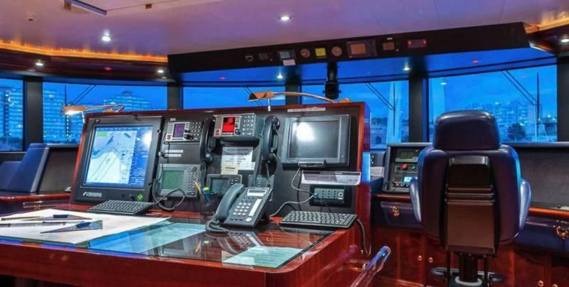 a computer desk with a couple of monitors and a keyboard aboard BEOL Yacht for Sale