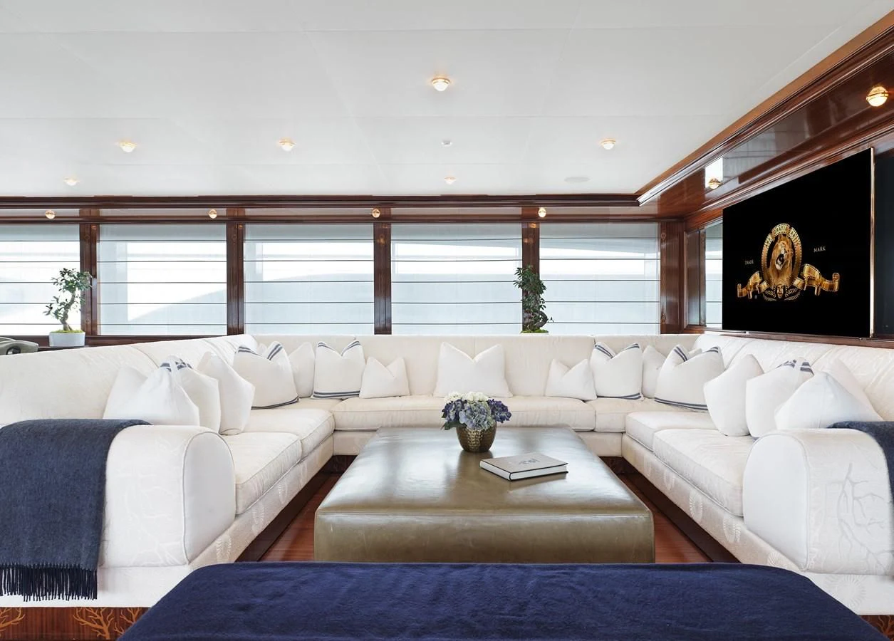 a living room with a white couch and a large window aboard BEOL Yacht for Sale