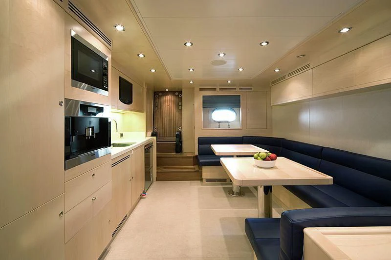 a kitchen with a table and a couch aboard BEOL Yacht for Sale