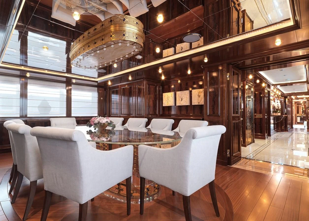 a room with tables and chairs aboard BEOL Yacht for Sale