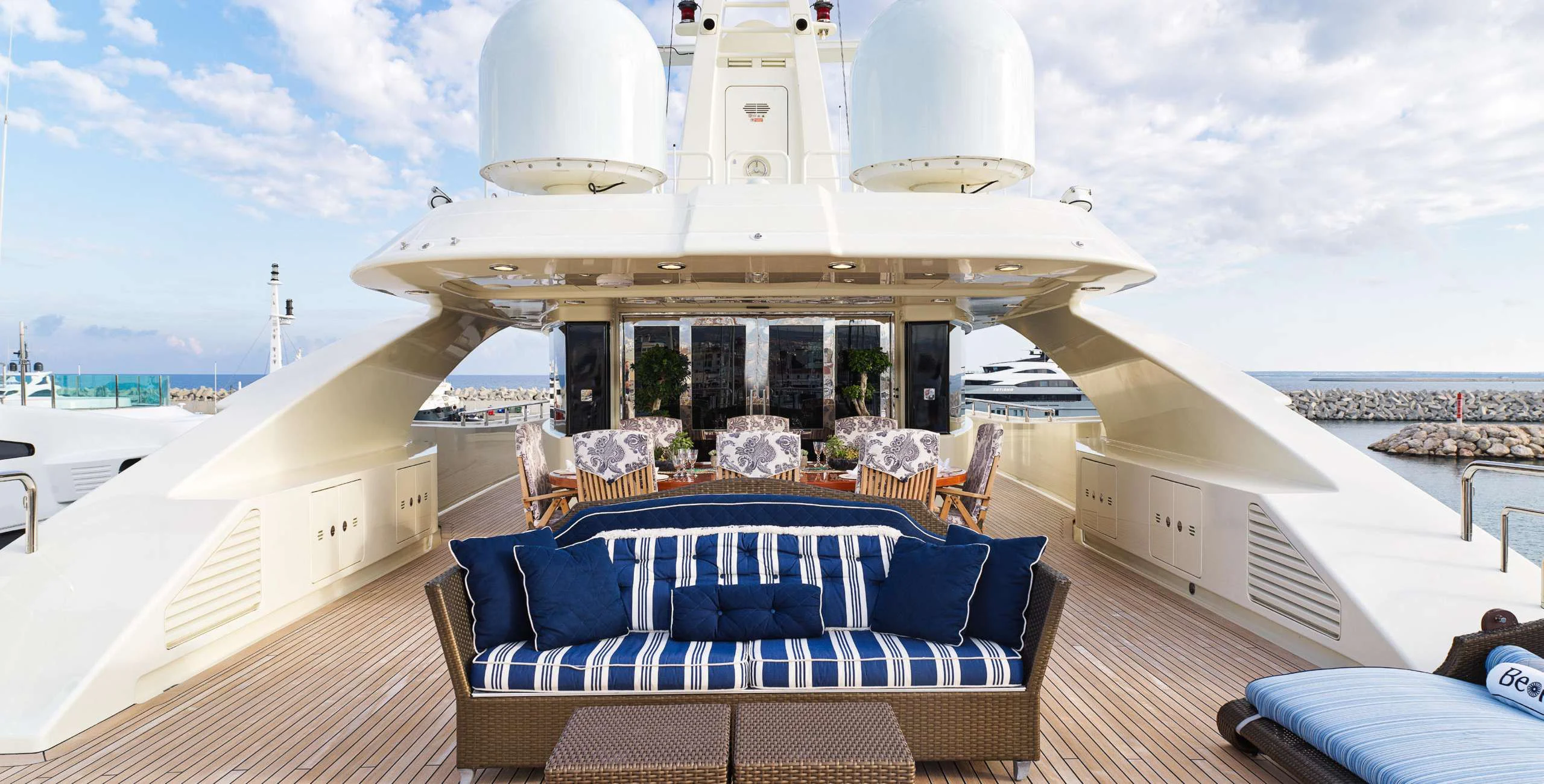 a large cruise ship with a deck and chairs on the deck aboard BEOL Yacht for Sale
