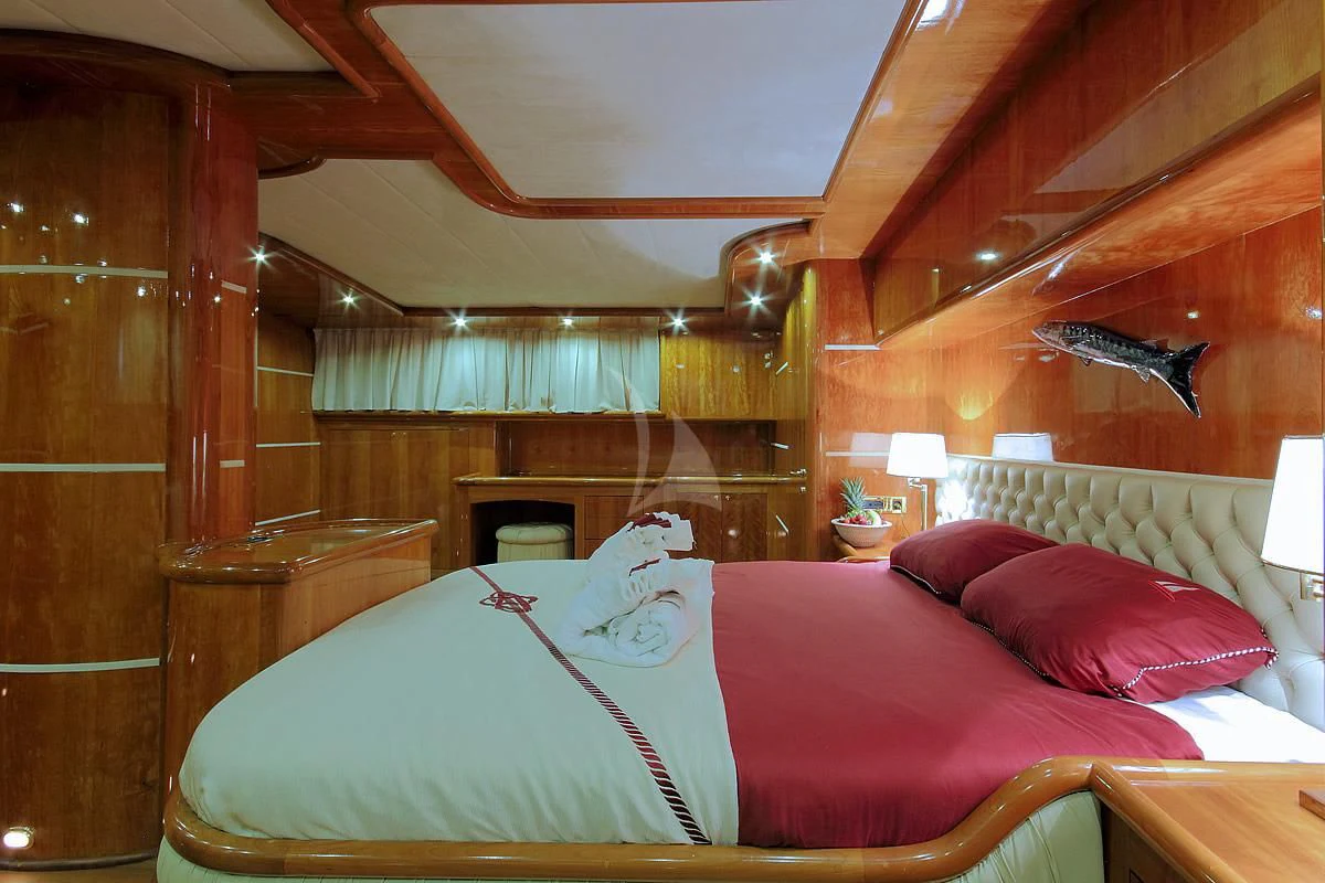 a bed with a pink comforter aboard SILVER MOON Yacht for Sale