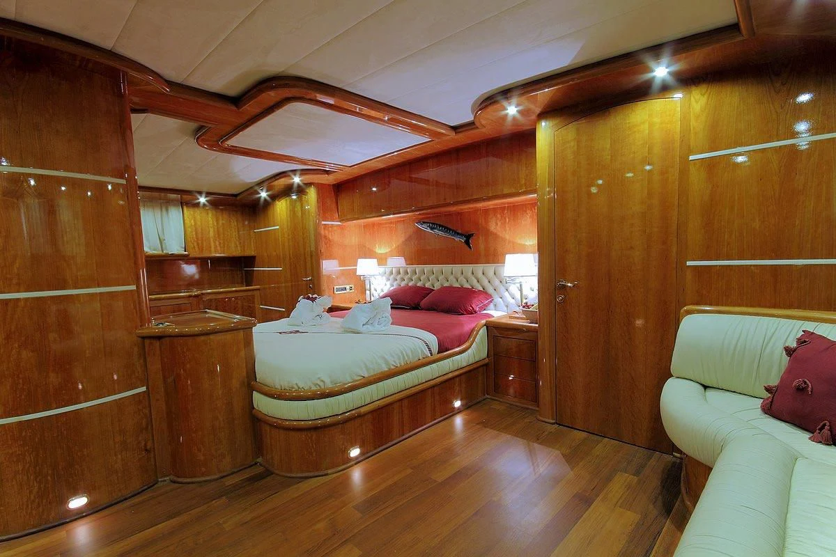 a room with a bed and a wood wall aboard SILVER MOON Yacht for Sale