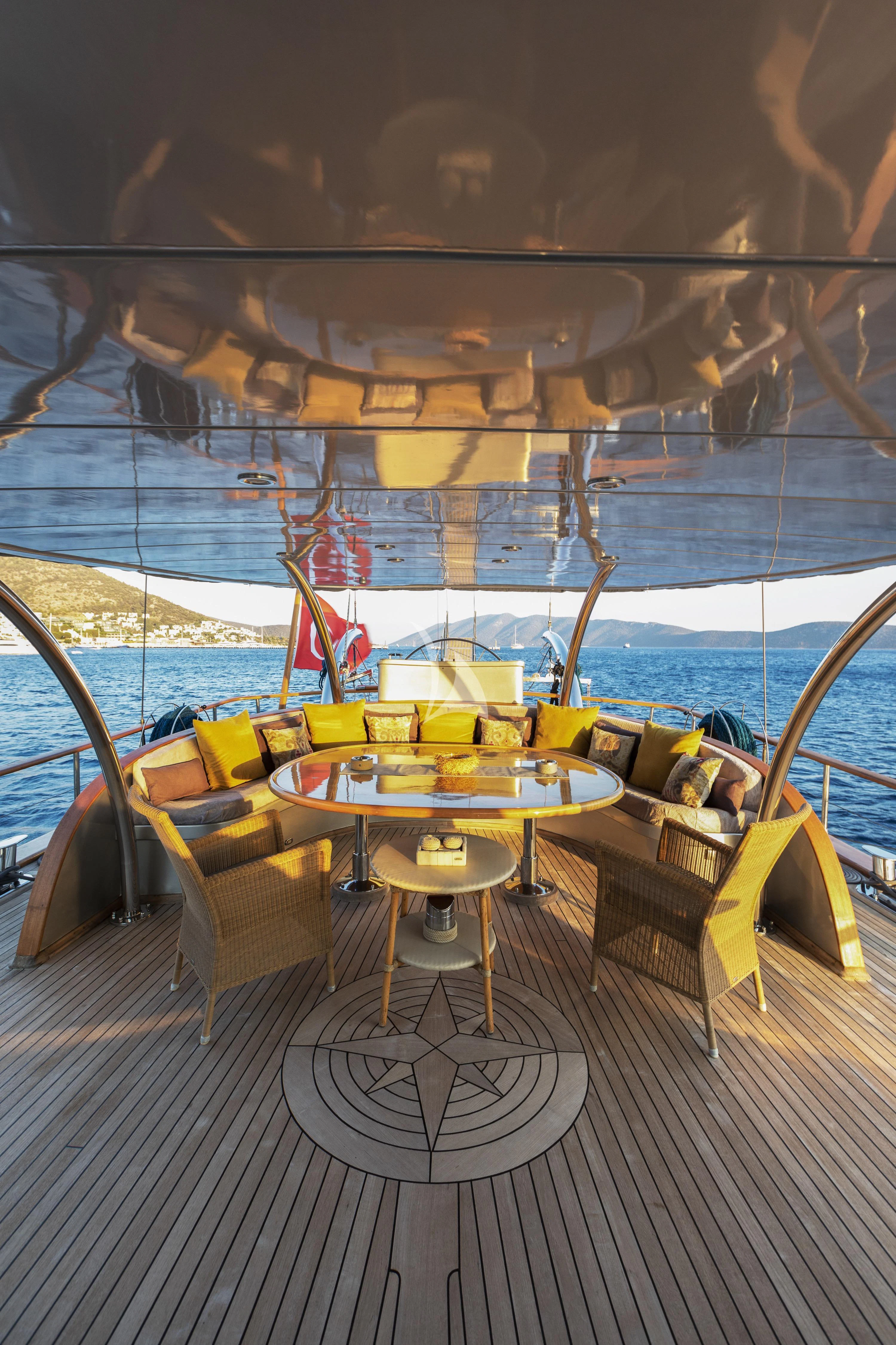 a boat with a table and chairs aboard SILVER MOON Yacht for Sale