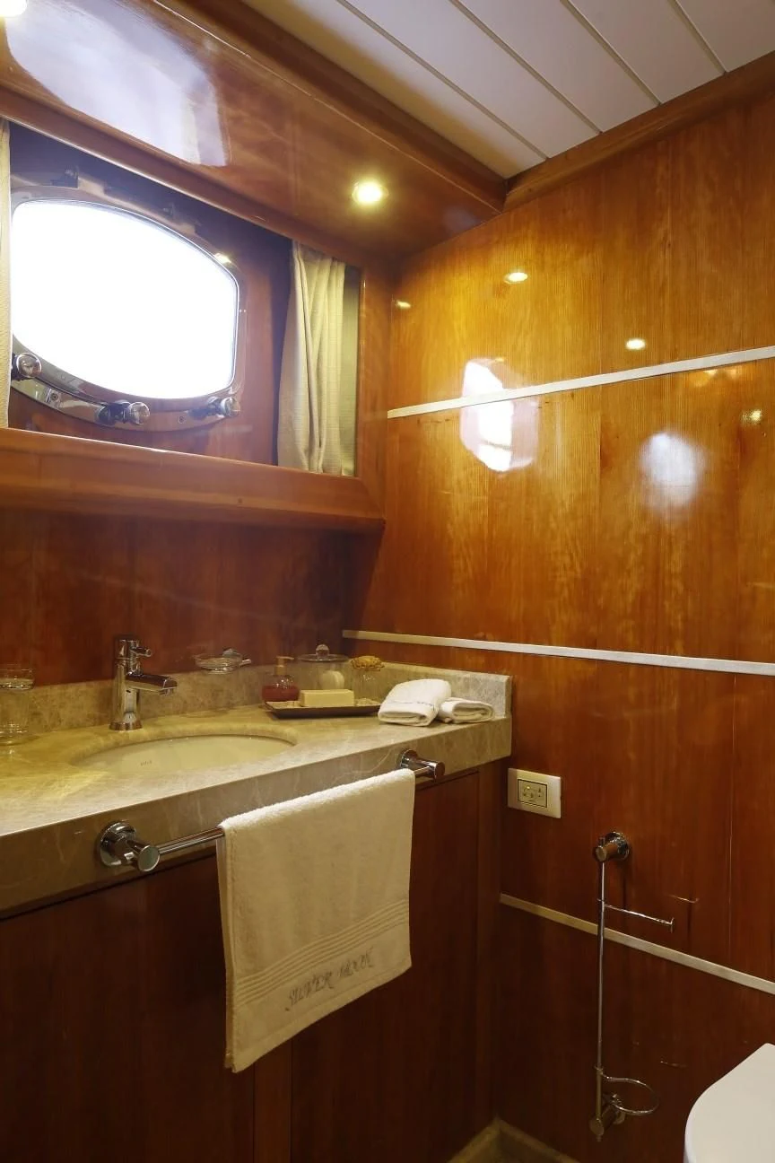 a bathroom with a sink and a mirror aboard SILVER MOON Yacht for Sale