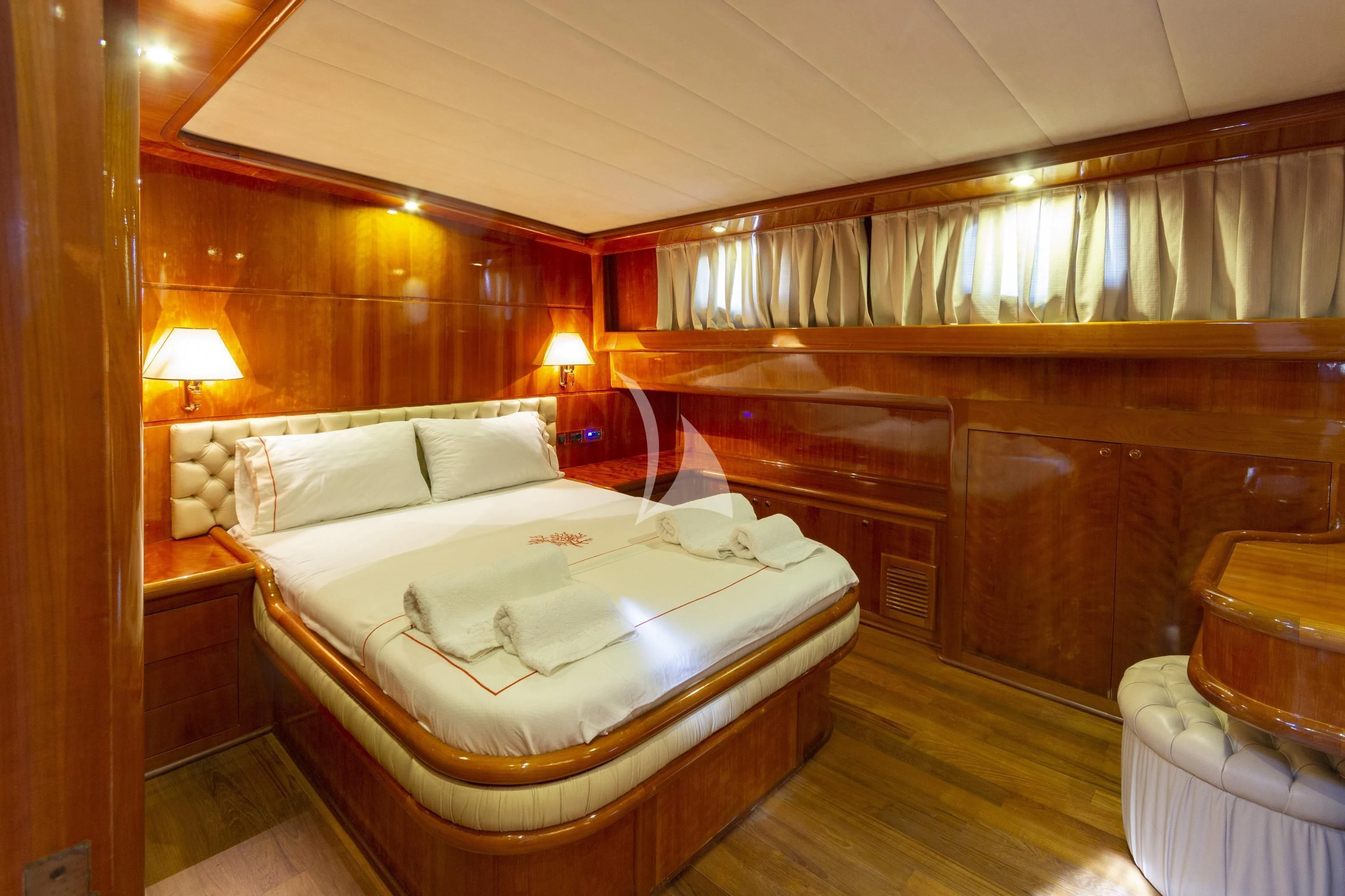 a bedroom with a bed and a chair aboard SILVER MOON Yacht for Sale