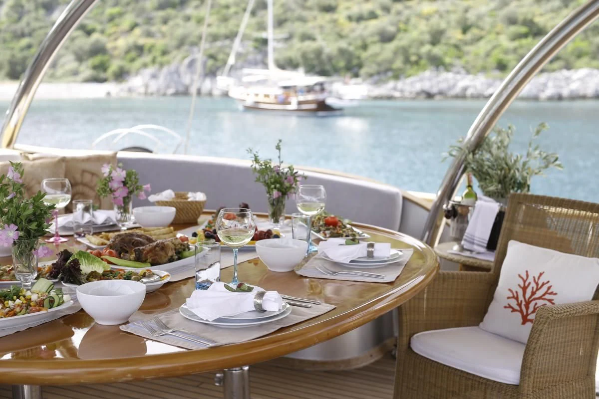 a table with plates and glasses on it aboard SILVER MOON Yacht for Sale