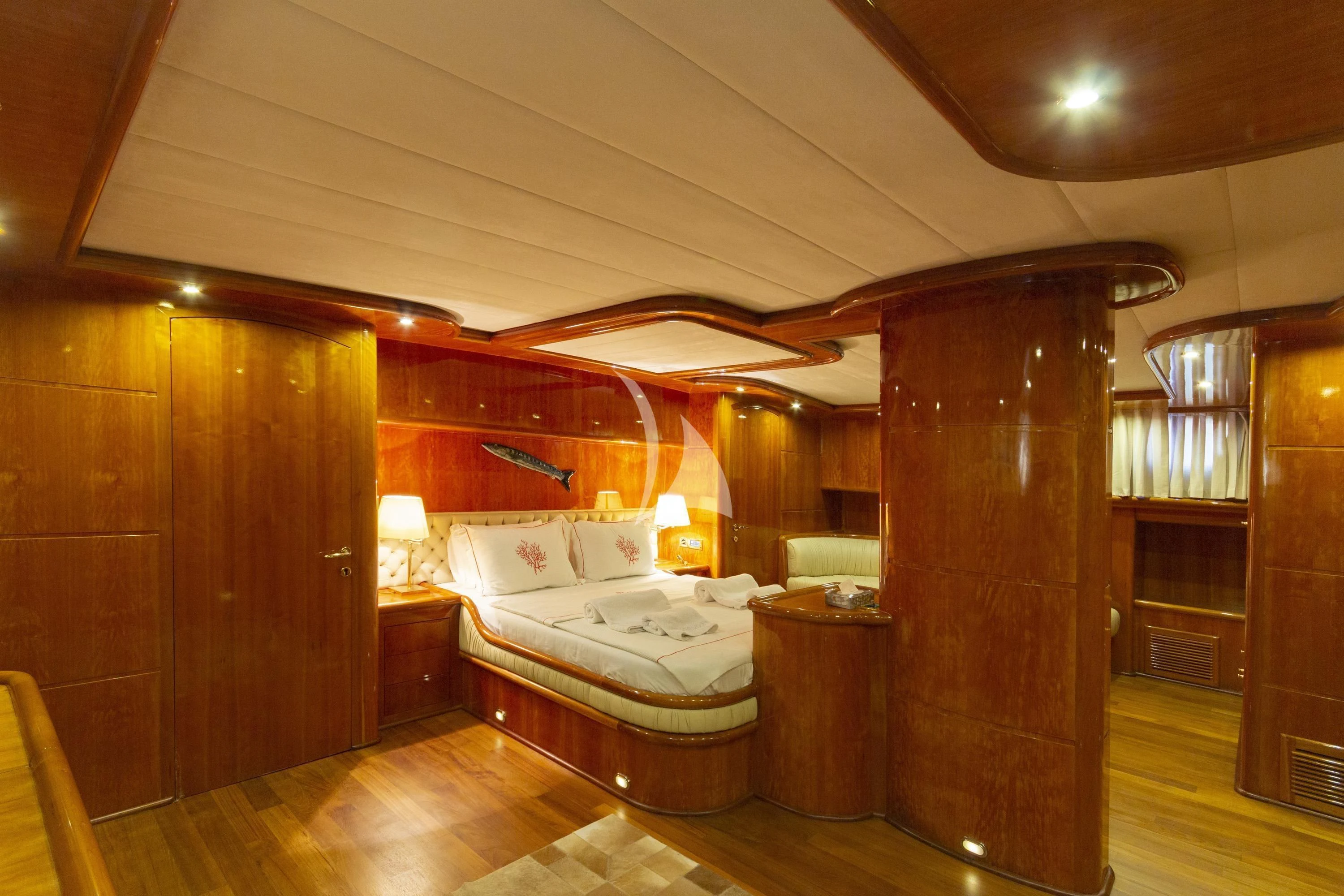 a bedroom with a bed and a wood door aboard SILVER MOON Yacht for Sale