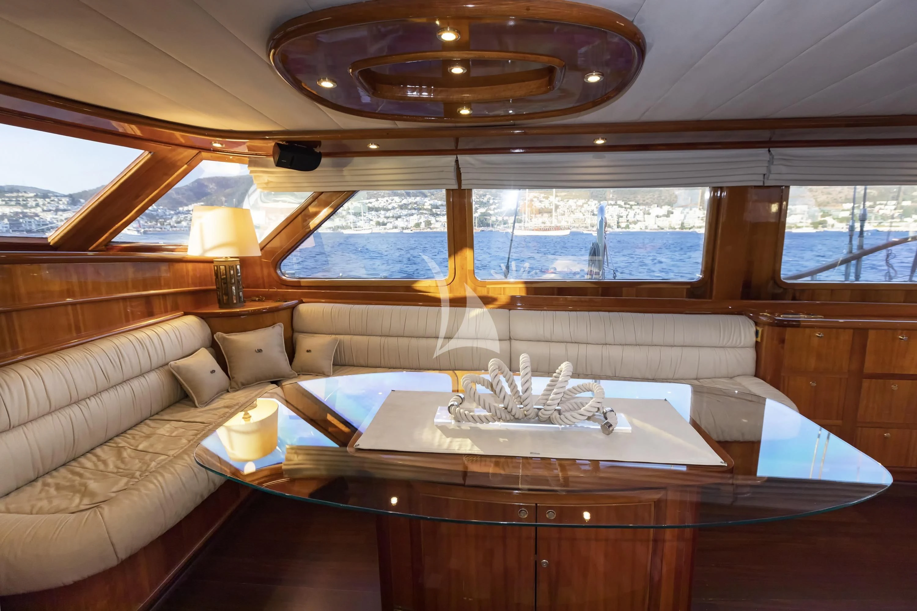 a room with a table and couch aboard SILVER MOON Yacht for Sale