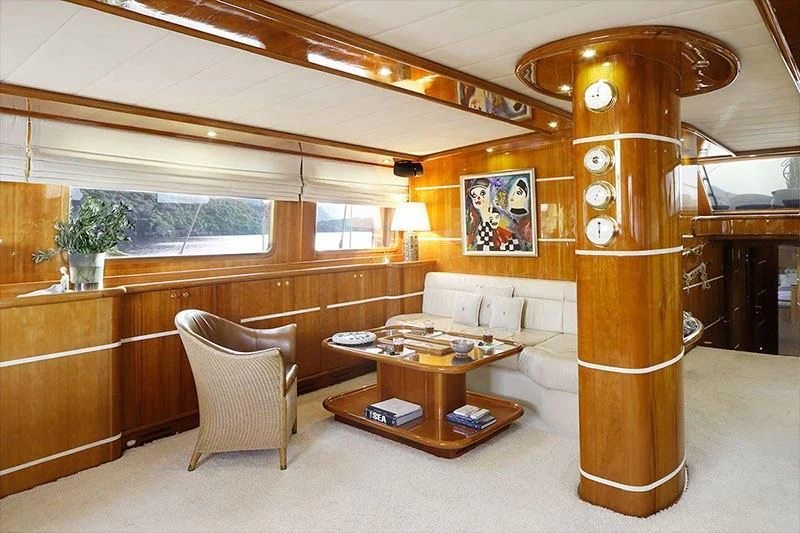 a room with a couch and a table and a chair aboard SILVER MOON Yacht for Sale