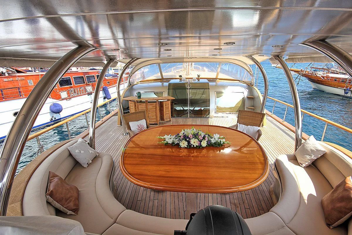 a boat with a table and chairs on a boat aboard SILVER MOON Yacht for Sale