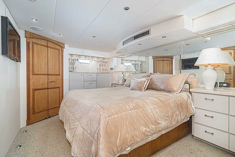 a bedroom with a bed and a desk aboard ECHOES Yacht for Sale