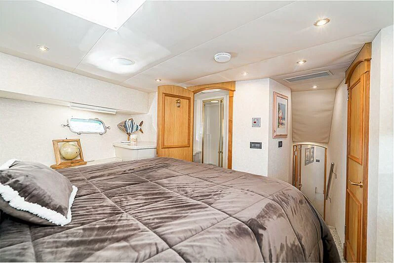 a bedroom with a bed and a desk aboard ECHOES Yacht for Sale