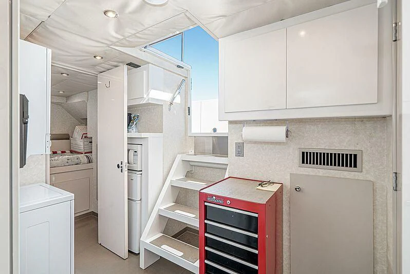a kitchen with white cabinets aboard ECHOES Yacht for Sale