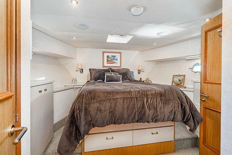 a bed with a black pillow on it aboard ECHOES Yacht for Sale