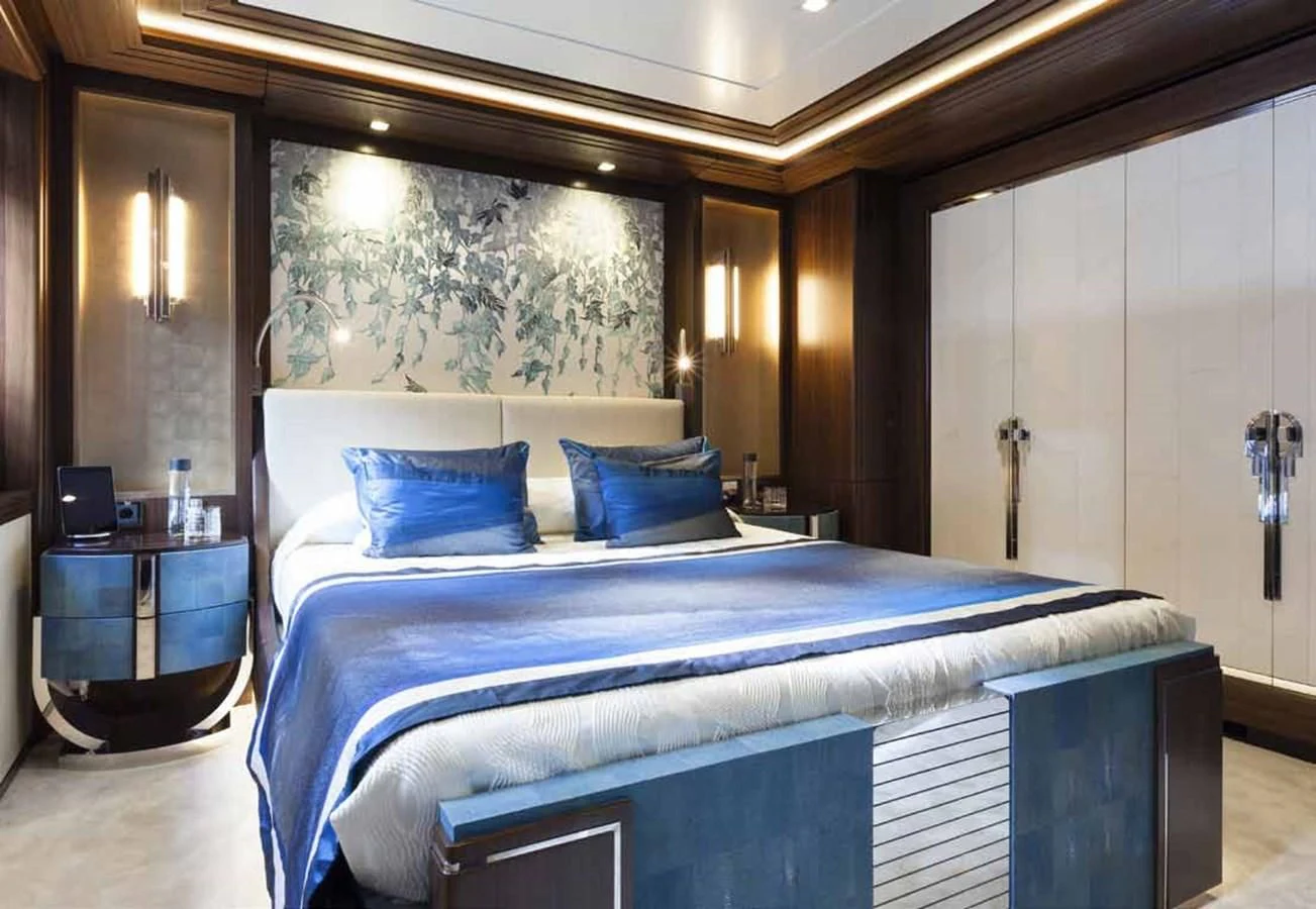a bed with blue sheets aboard JULIA Yacht for Sale