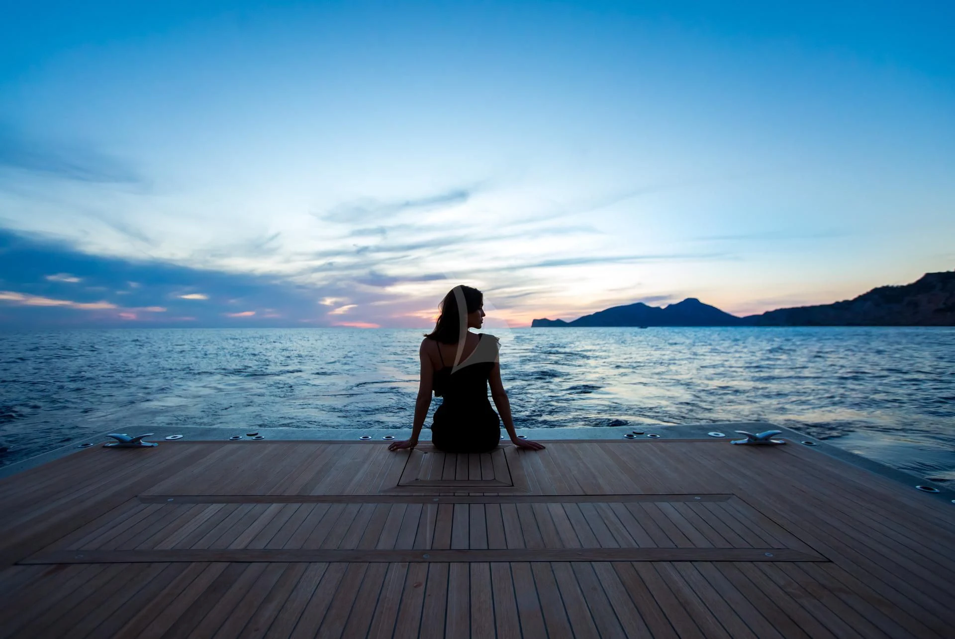 a person sitting on a dock aboard JULIA Yacht for Sale