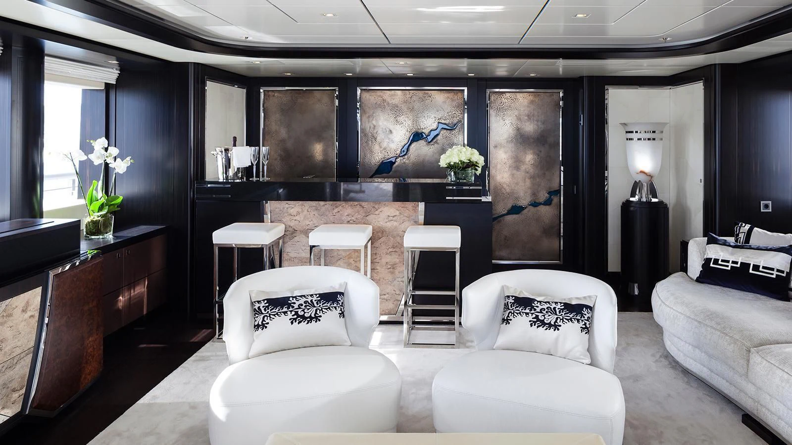a room with couches and a table and chairs aboard JULIA Yacht for Sale